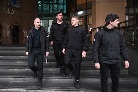 Thomas Sewell (left) with NSN figures (L-R) Jimeone Roberts, Nathan Bull and Jacob Hersant, outside the Melbourne Magistrates’ Court in September.
