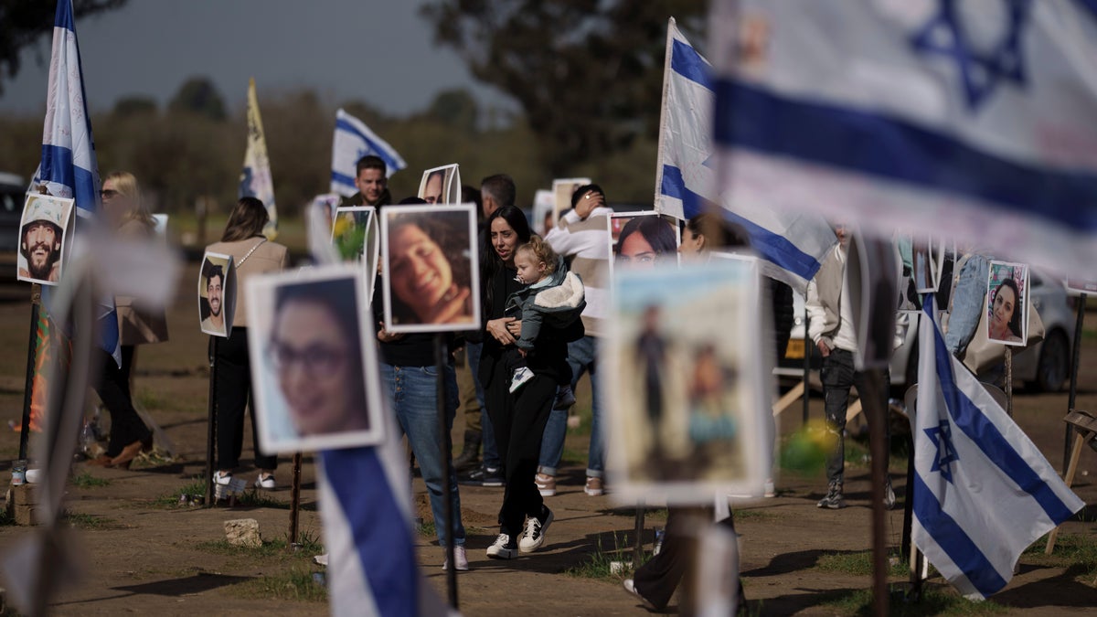 People visiting the site of the Nova music festival attack in Re'im, Israel