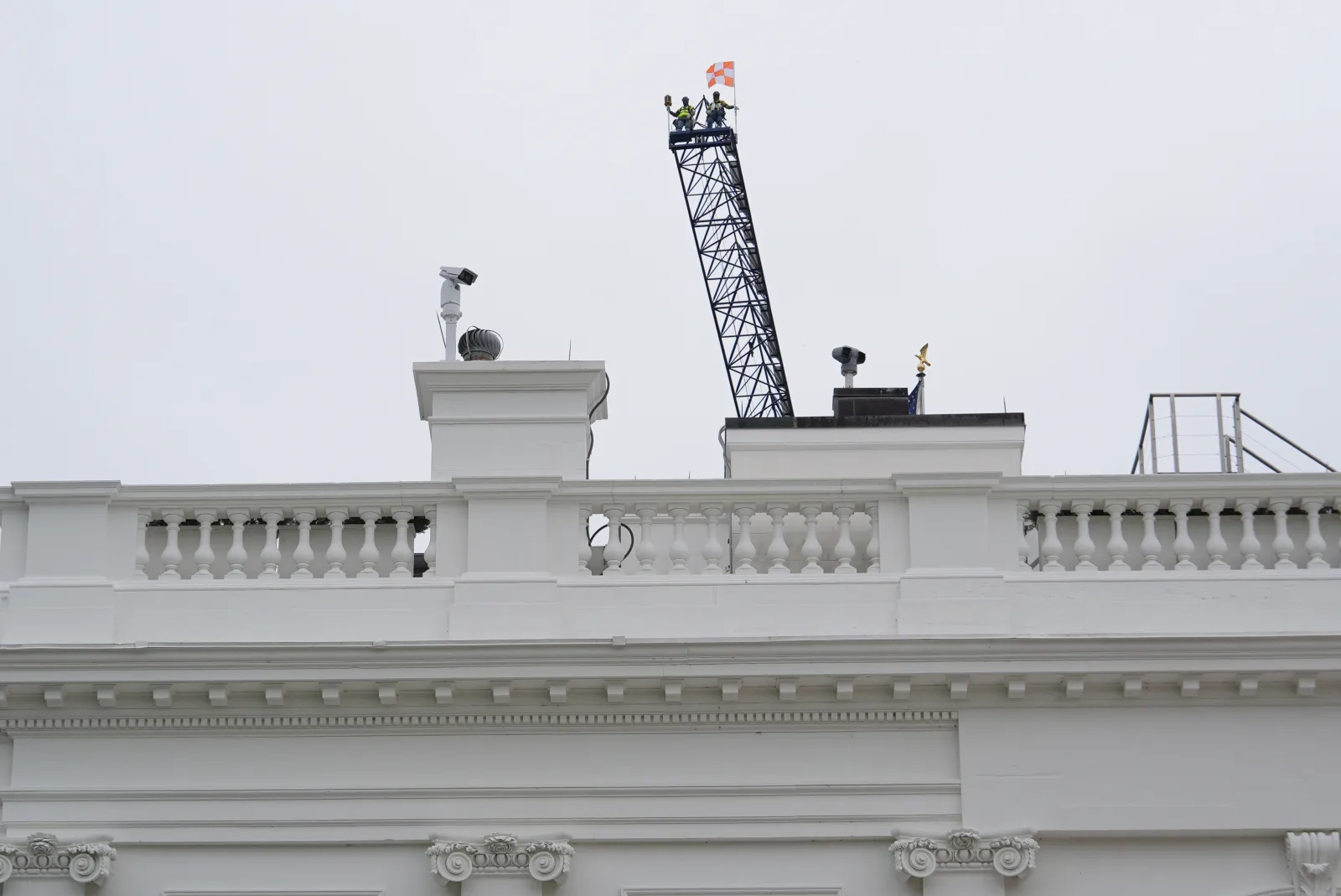 Two people look down at the White House from a crane on April 28 in Washington. (AP Photo/Julia Demaree Nikhinson)