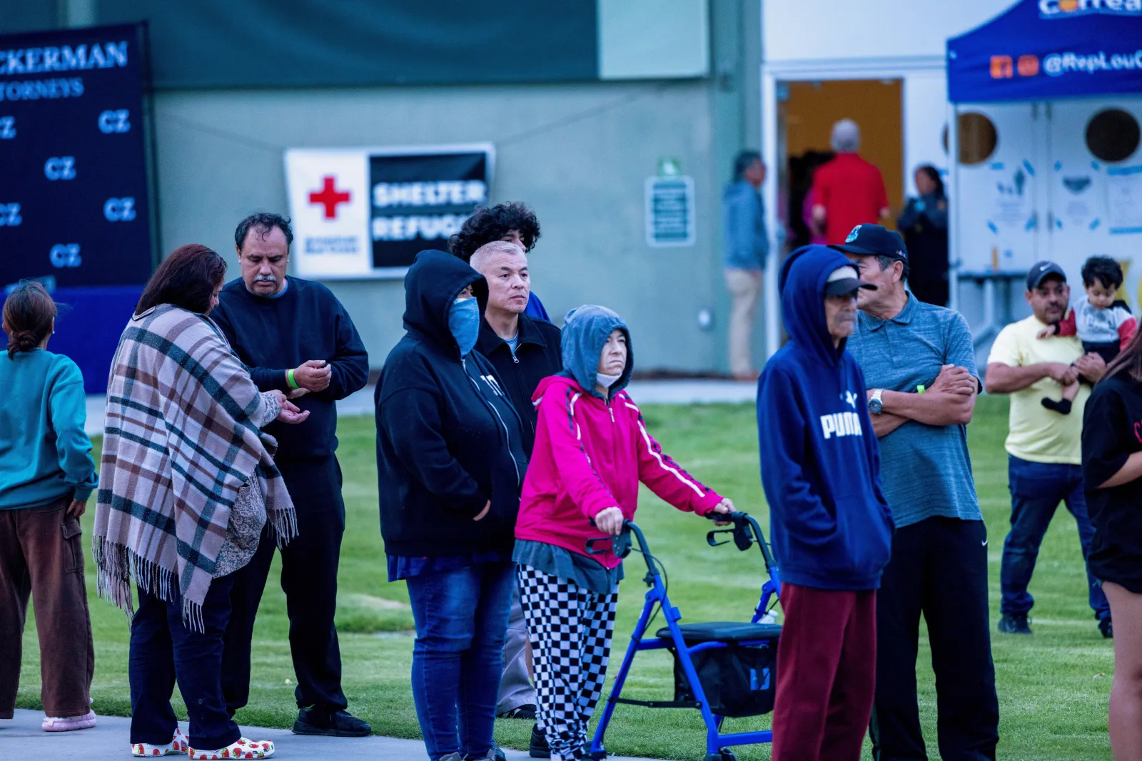 People line up for dinner outside Freedom Hall, where an evacuation center is set up, at Mile Square Regional Park in Fountain Valley, California, on May 23, following Thursday's chemical tank damage in Garden Grove. (AP Photo/Jill Connelly)