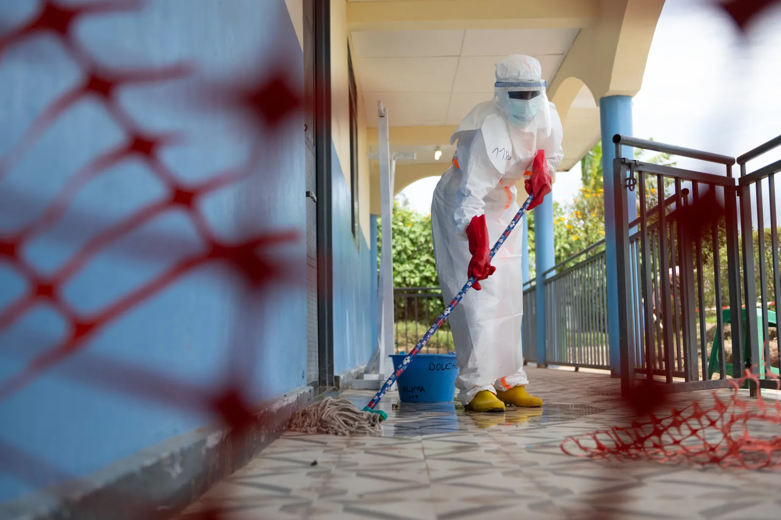 A health worker mops the floor at the Ebola treatment center in Rwampara, Congo, on May 29. (AP Photo/Moses Sawasawa)