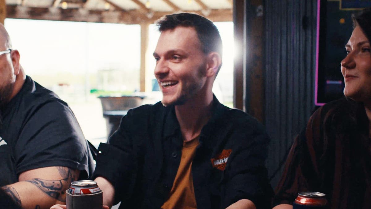 Austin Ahlman drinks a beer in a campaign ad.