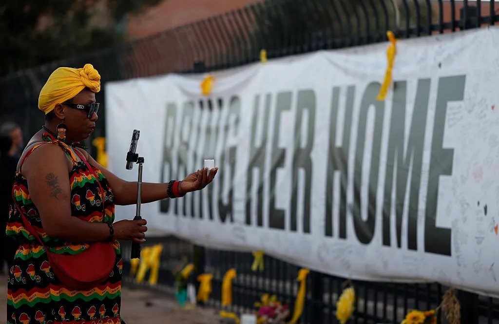 A woman visits a makeshift memorial for Nancy Guthrie in front of the KVOA television station on March 1, 2026, in Tucson, Arizona.