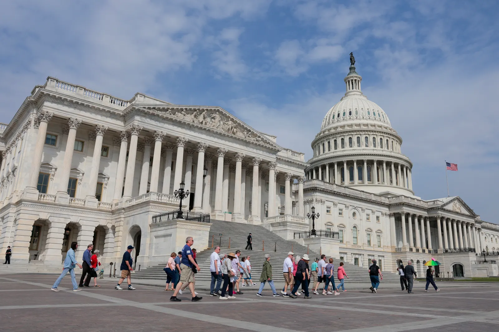 People walking outside the U.S. Capitol building, on April 13, 2026, in Washington, D.C.