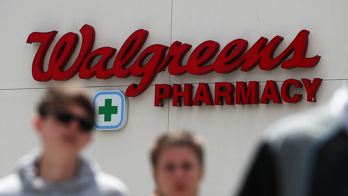 Pedestrians walking past a Walgreens store in San Francisco