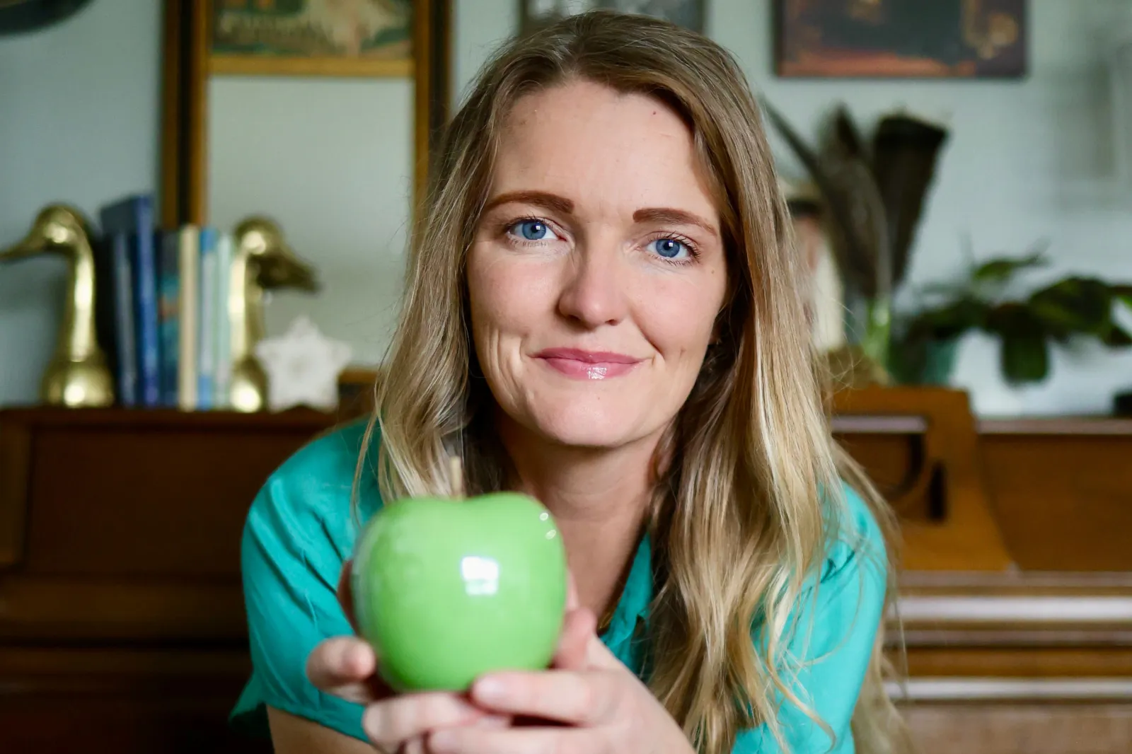 Mom Lauran Newman holds a glass green apple, also known as the "truth apple."