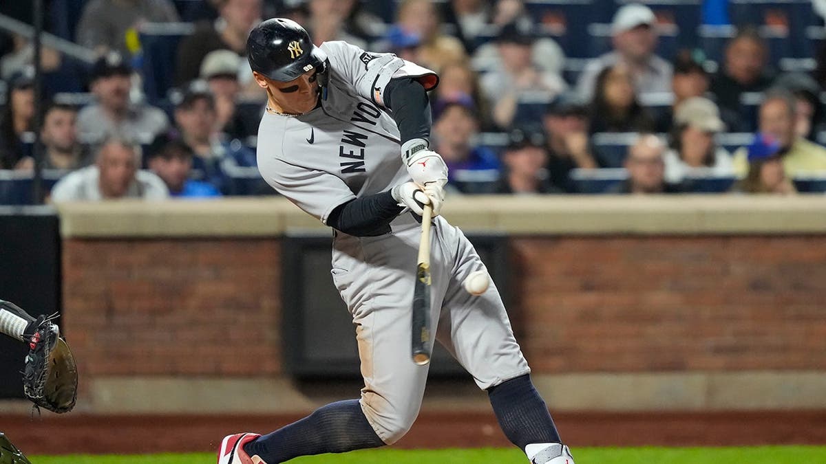New York Yankees' Aaron Judge hitting a double during a baseball game.
