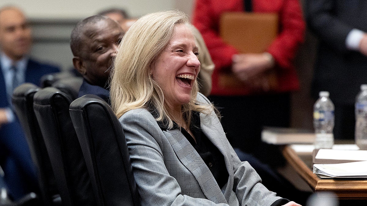 Virginia Gov. Abigail Davis Spanberger laughing during a ceremony in a court in Richmond
