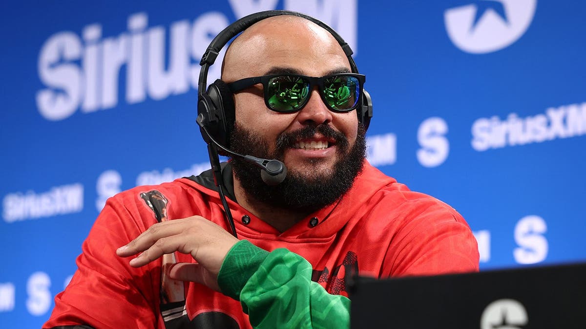 AJ Francis standing inside SiriusXM Radio Row at Super Bowl LX in San Francisco