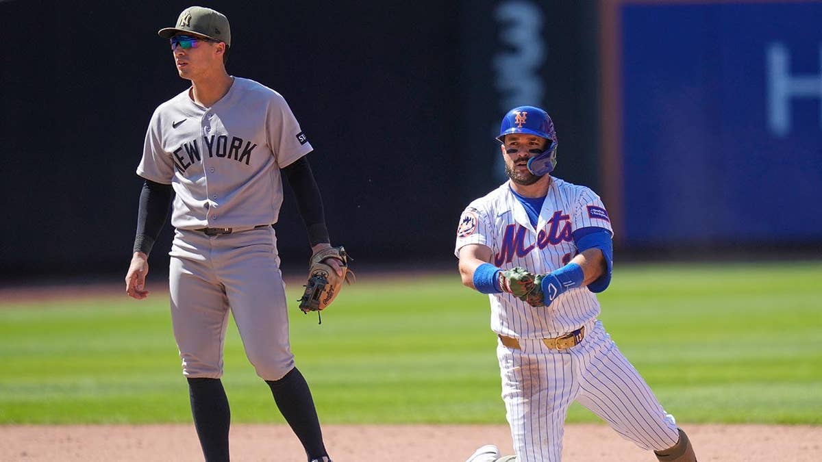 New York Yankees shortstop Anthony Volpe watching New York Mets' Luis Torrens after hitting a two-run RBI double.