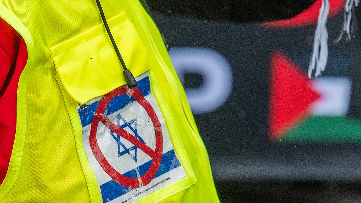 An anti-Israel protester wearing a high-visibility jacket during a march near Sydney Harbor Bridge