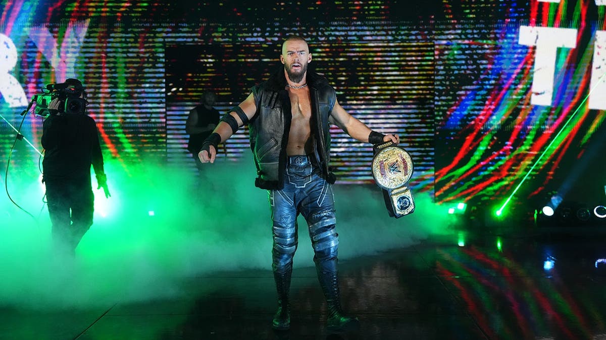 World Tag Team Champion Austin Theory entering arena at Greensboro Coliseum Complex