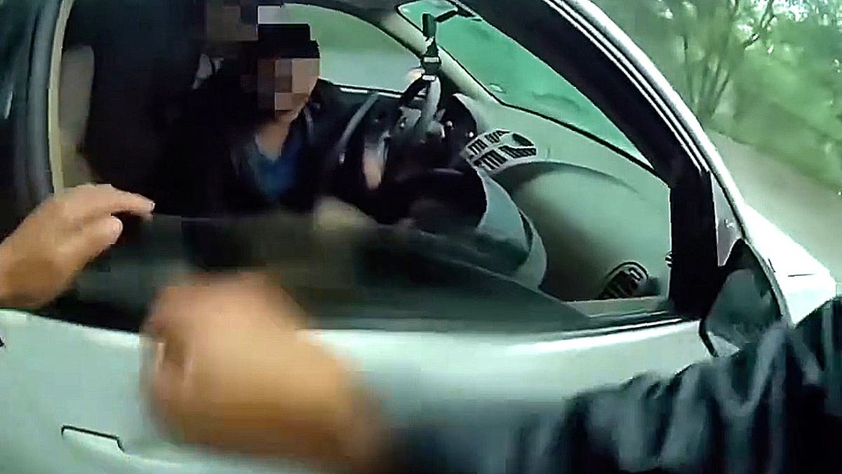 Officer at car window during rescue