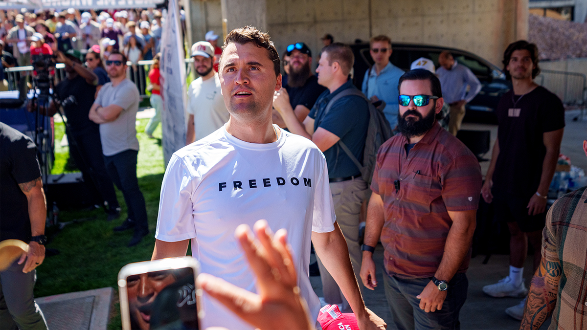 Charlie Kirk speaking at Utah Valley University addressing a crowd.