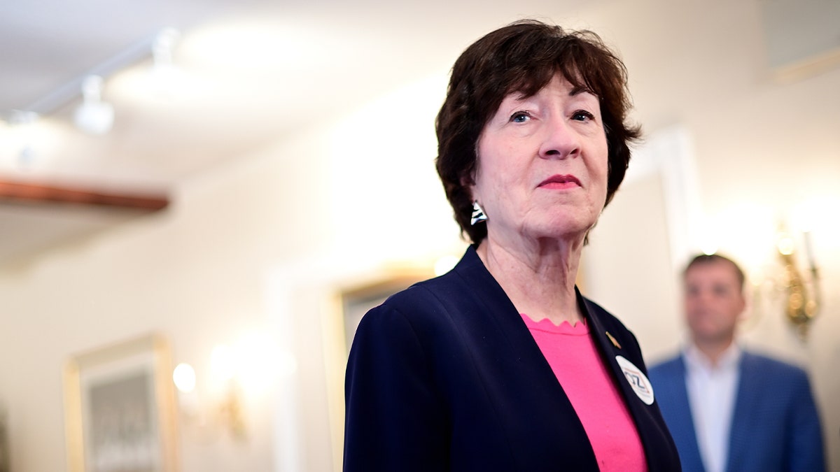 Sen. Susan Collins speaking at a podium indoors