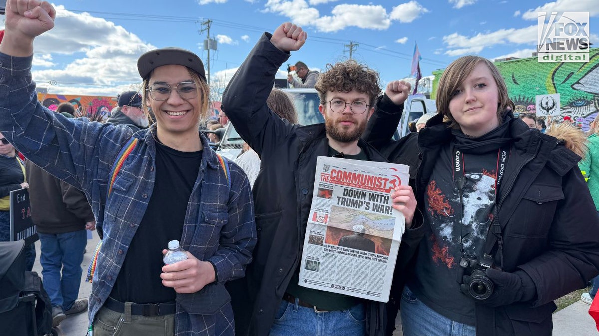 Protesters holding Communist newspaper at Minneapolis May Day rally