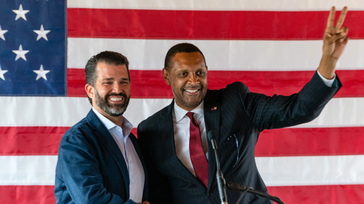 Donald Trump Jr., executive vice president of development and acquisitions for the Trump Organization, shakes hands with Vernon Jones during a campaign event in Cumming, Georgia.