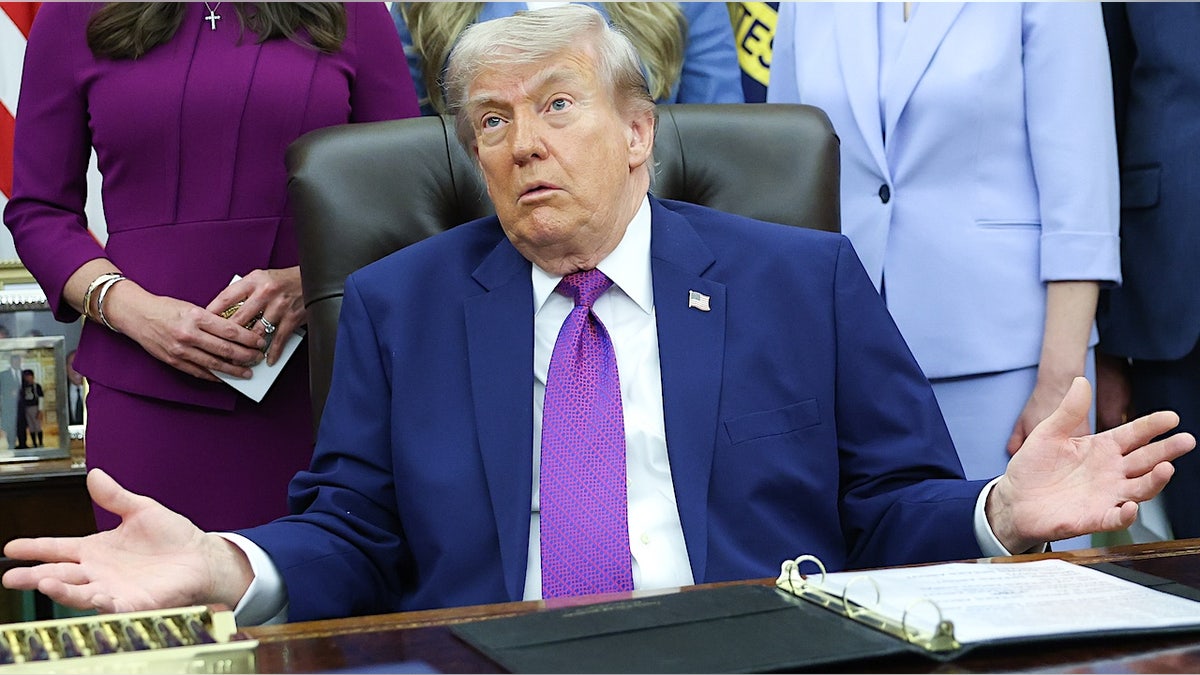 donald trump spreads out his arms in disbelief