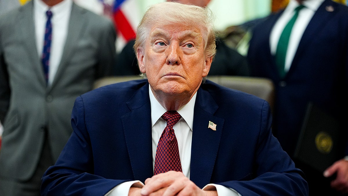 President Donald Trump listening in the Oval Office of the White House