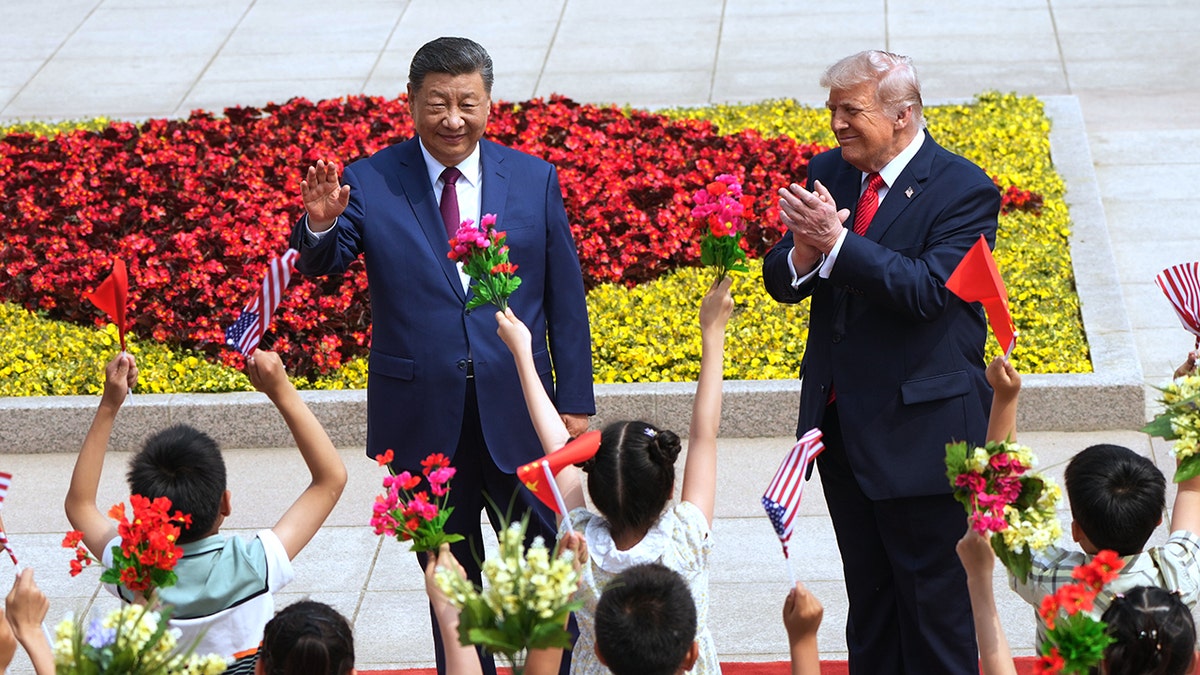 President Donald Trump and President Xi Jinping greeting children at the Great Hall of the People in Beijing