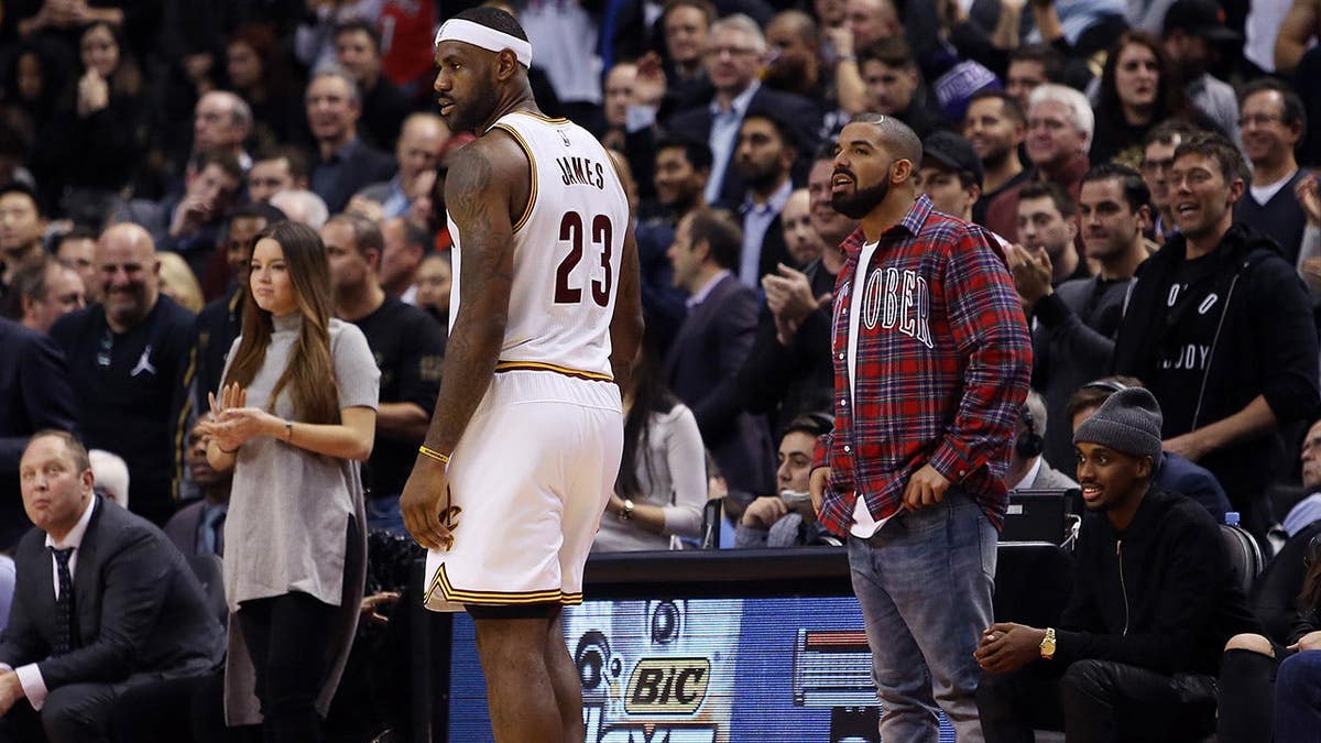 Singer Drake talks to LeBron James during an NBA game at the Air Canada Centre in Toronto