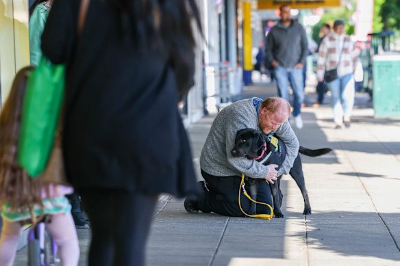 Phillip Chalker and his assistance dog, Donna, during an outing to a shopping strip in Traralgon.