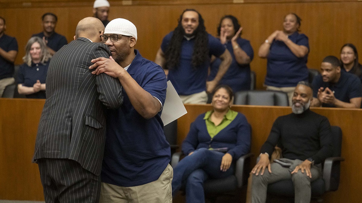 Harold Cunningham receiving best speaker award from Magistrate Judge Zia M. Faruqui at Prettyman Federal Courthouse