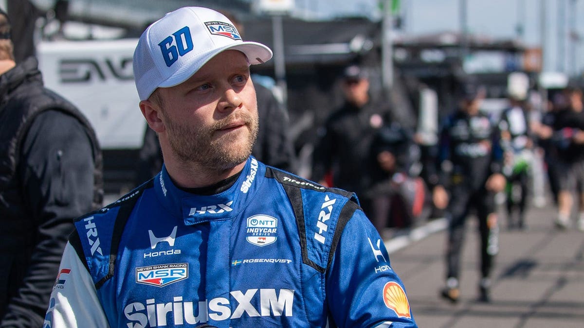 Felix Rosenqvist driving an IndyCar out of pit lane at Indianapolis Motor Speedway