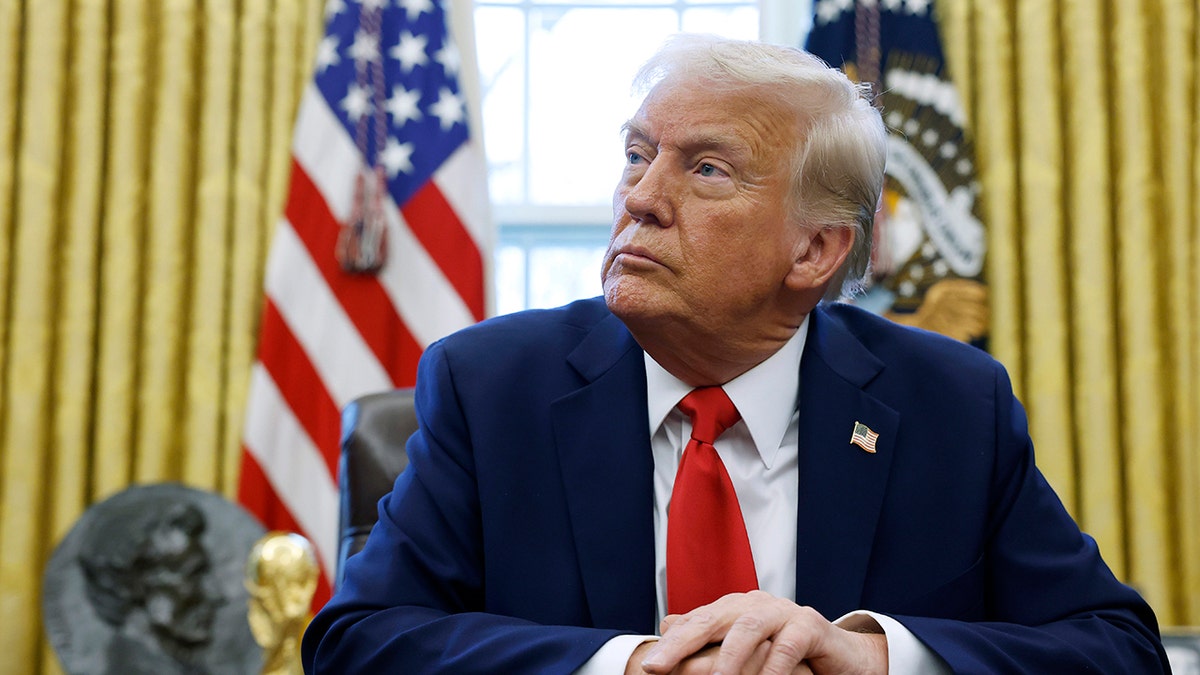 President Donald Trump speaking to reporters in the Oval Office of the White House