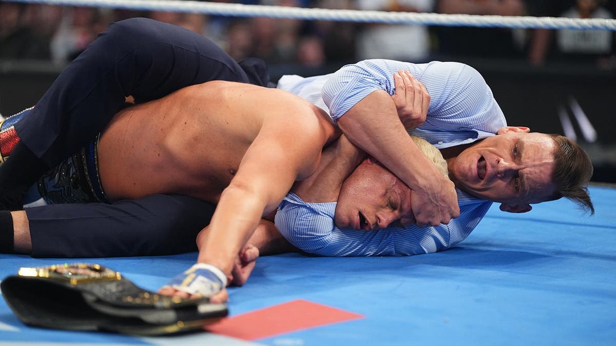 Gunther attacking Cody Rhodes in a wrestling ring at Rupp Arena