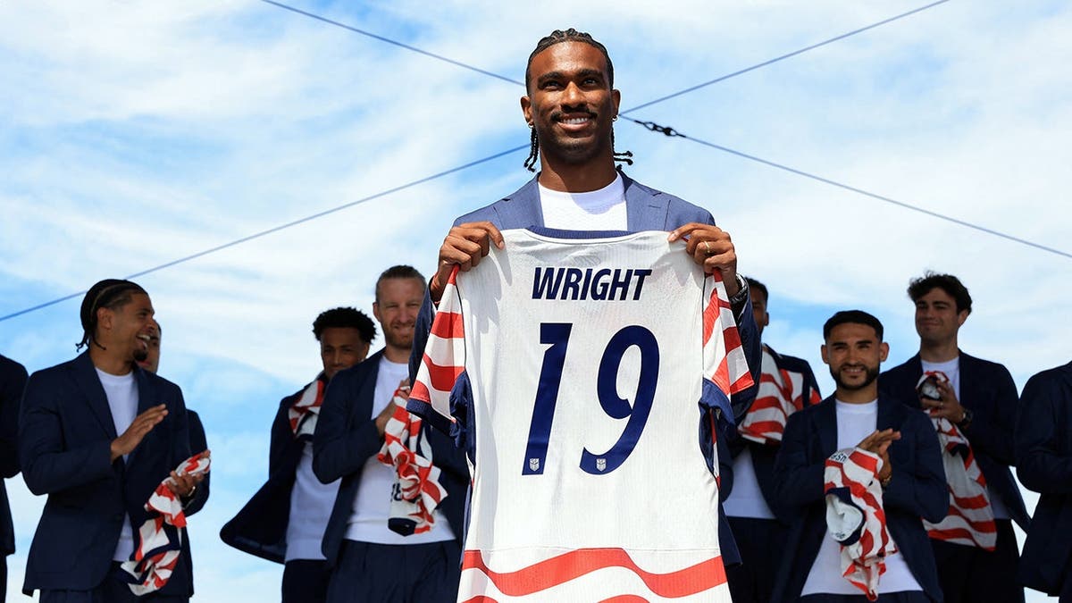 USMNT forward Haji Wright posing with his jersey in New York