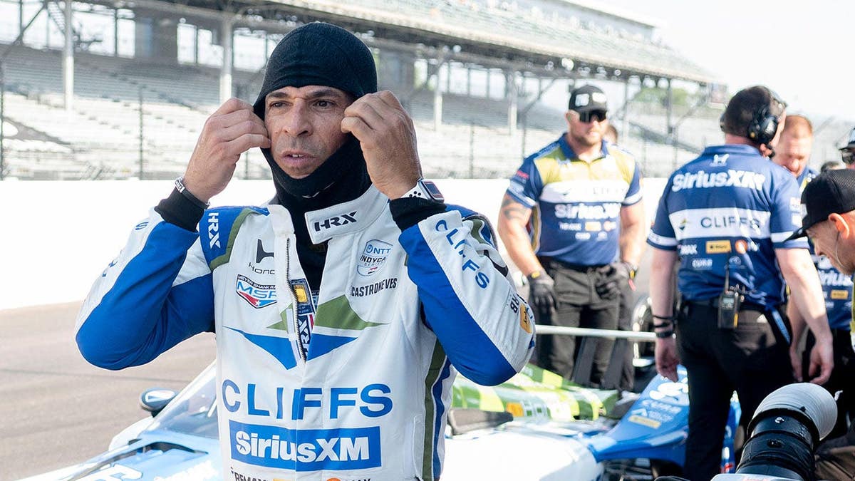 Helio Castroneves preparing to get in his race car at Indianapolis Motor Speedway