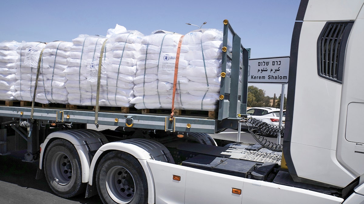 A truck carrying humanitarian aid drives to the Kerem Shalom crossing at the Israel-Gaza border