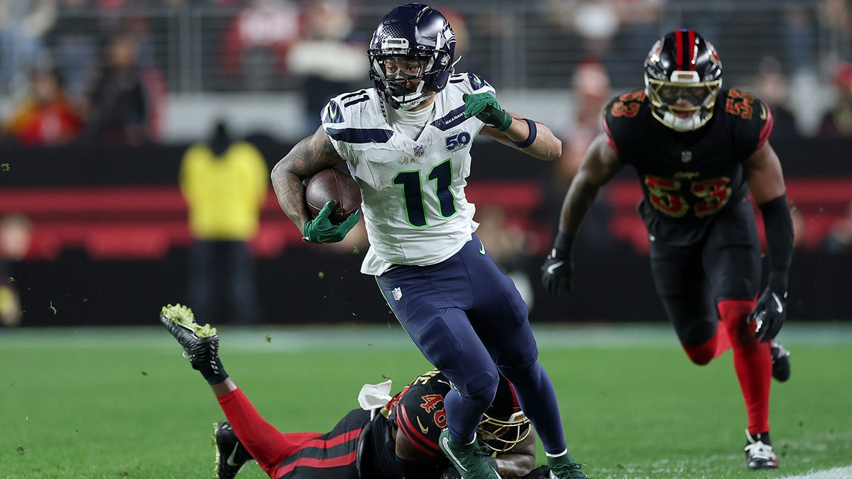 Jaxon Smith-Njigba running with football during NFL game at Levi's Stadium