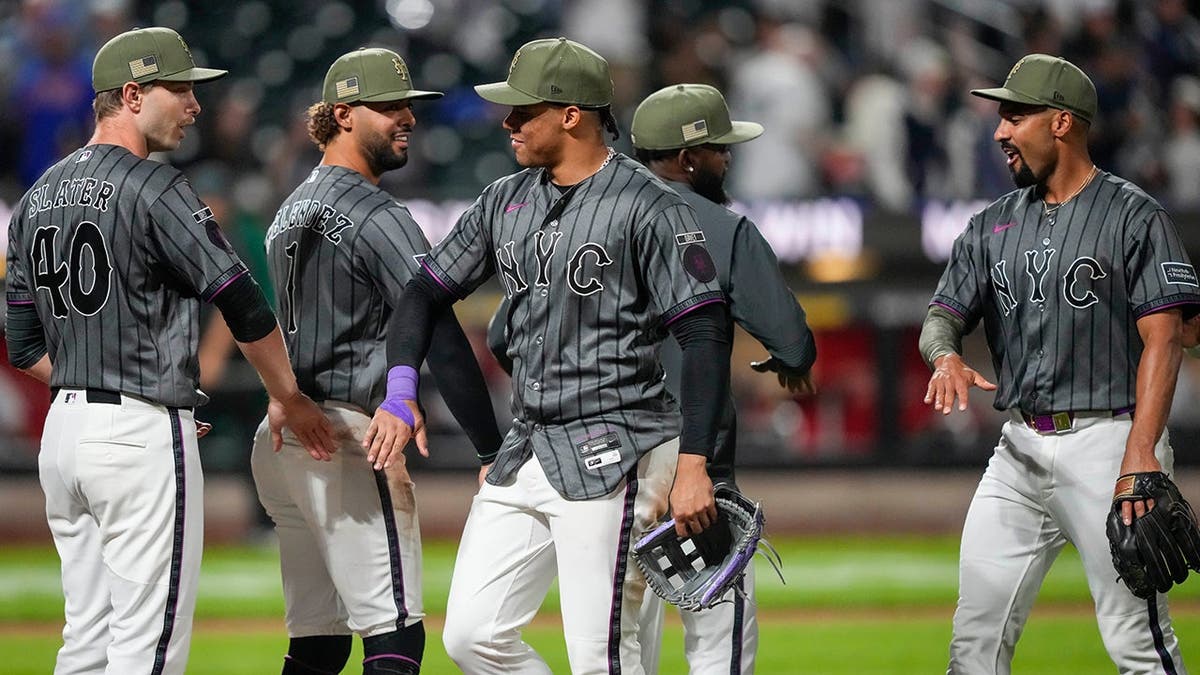 New York Mets' Juan Soto celebrating with Austin Slater on baseball field