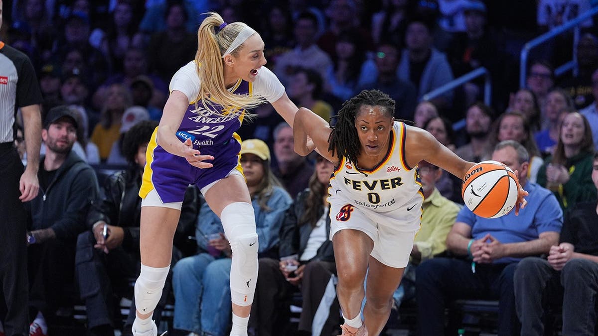 Indiana Fever guard Kelsey Mitchell steals the ball from Los Angeles Sparks forward Cameron Brink during a basketball game