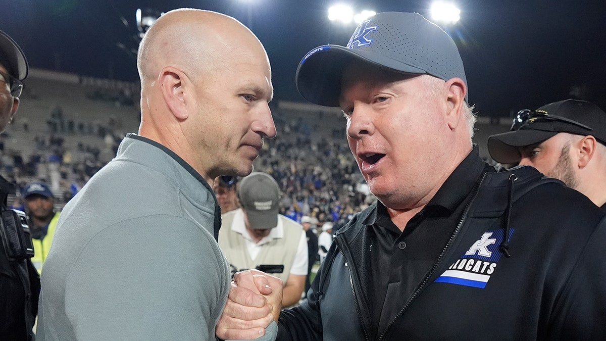 Kentucky head coach Mark Stoops and Vanderbilt head coach Clark Lea meeting on football field