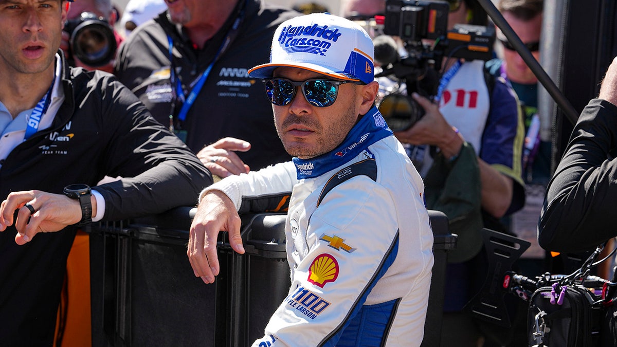 Kyle Larson standing at Indianapolis Motor Speedway waiting for practice to start