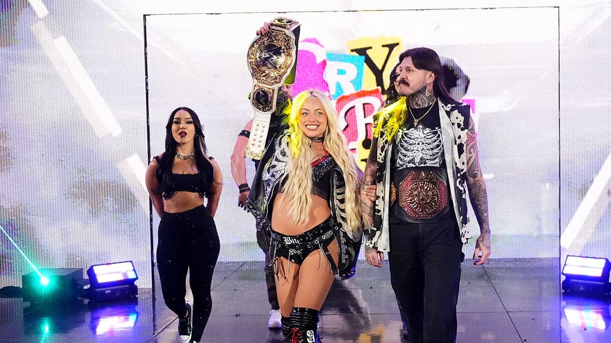 Liv Morgan entering arena with Raquel Rodriguez, Roxanne Perez and Dominik Mysterio
