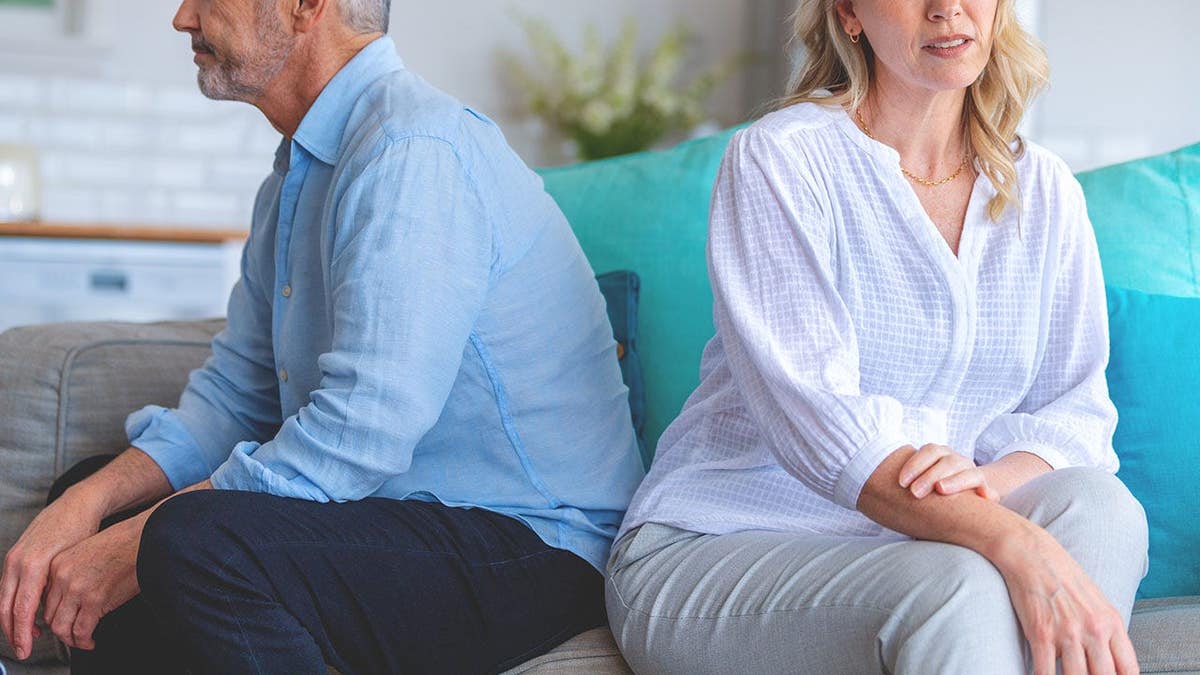 A woman is considering getting a boob job to keep her husband of 30 years faithful.