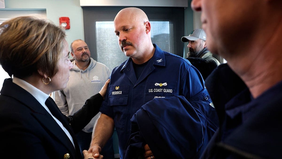 Massachusetts Governor Maura Healey talking with Captain Jamie Frederick of the U.S. Coast Guard