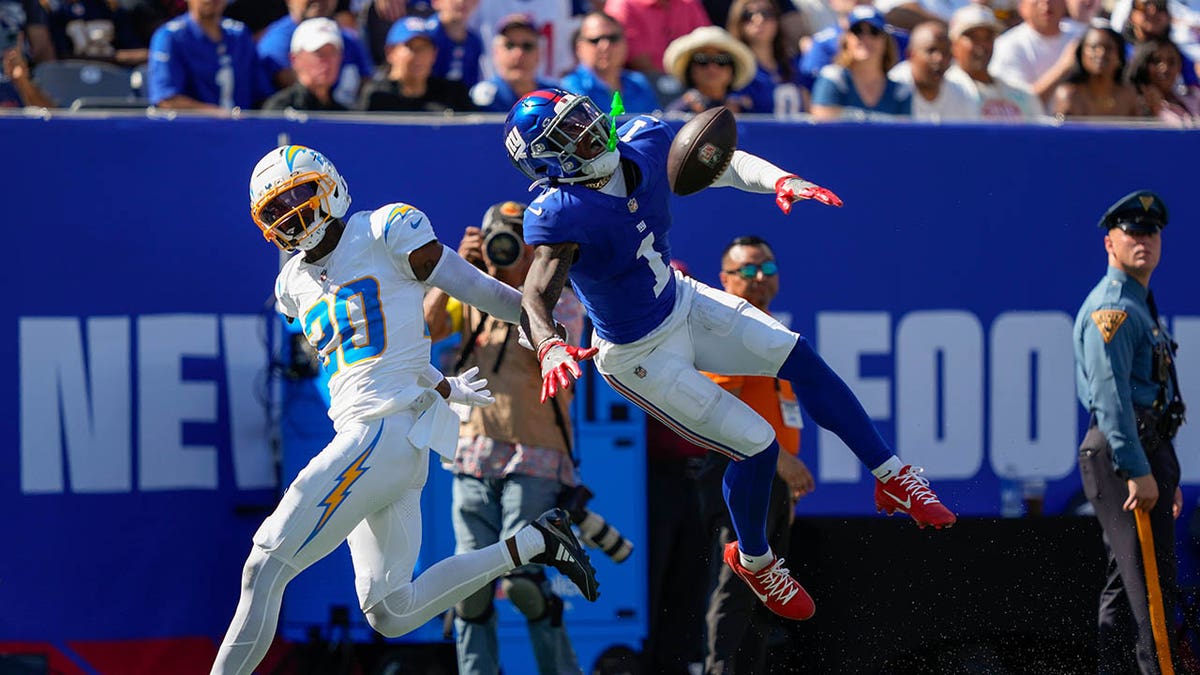 New York Giants wide receiver Malik Nabers leaps to catch a pass against Los Angeles Chargers cornerback Cam Hart