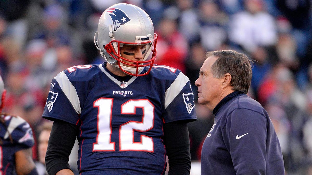 New England Patriots quarterback Tom Brady talks with head coach Bill Belichick on the sidelines