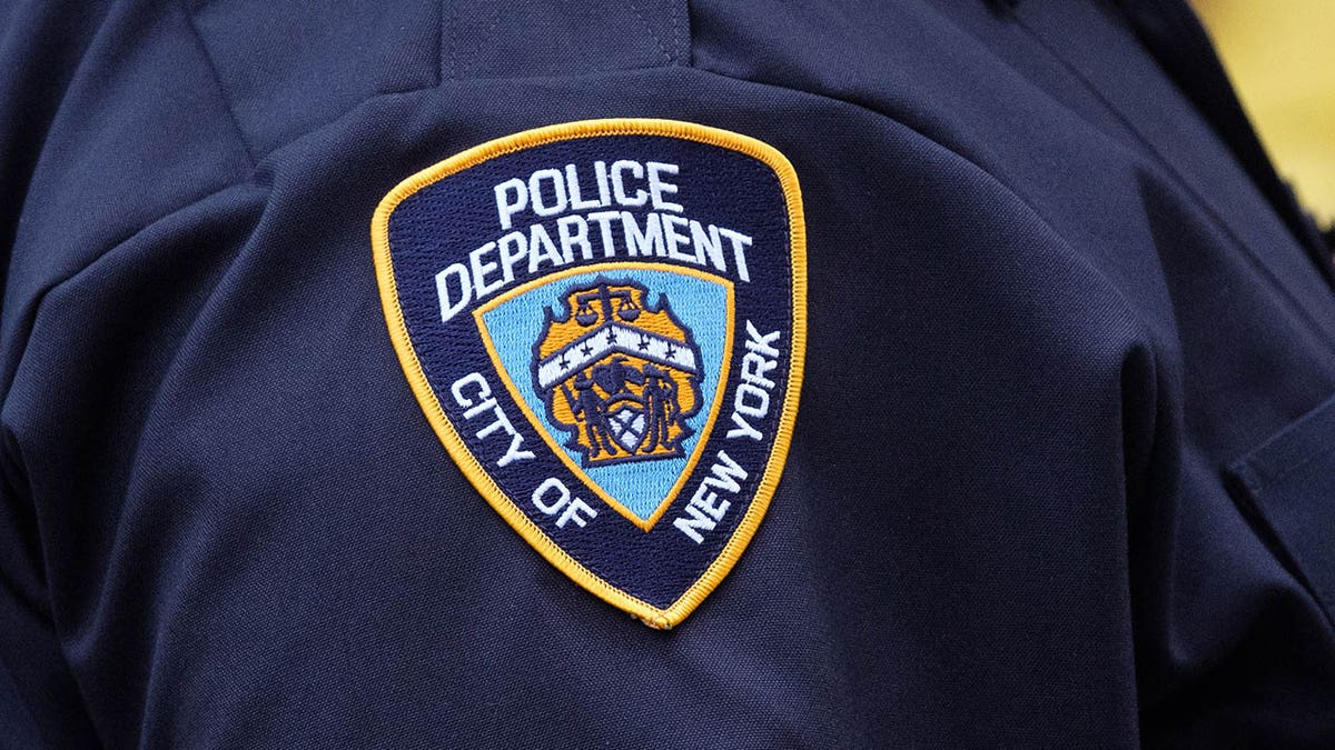 New York City Police Department logo on an officer's uniform.
