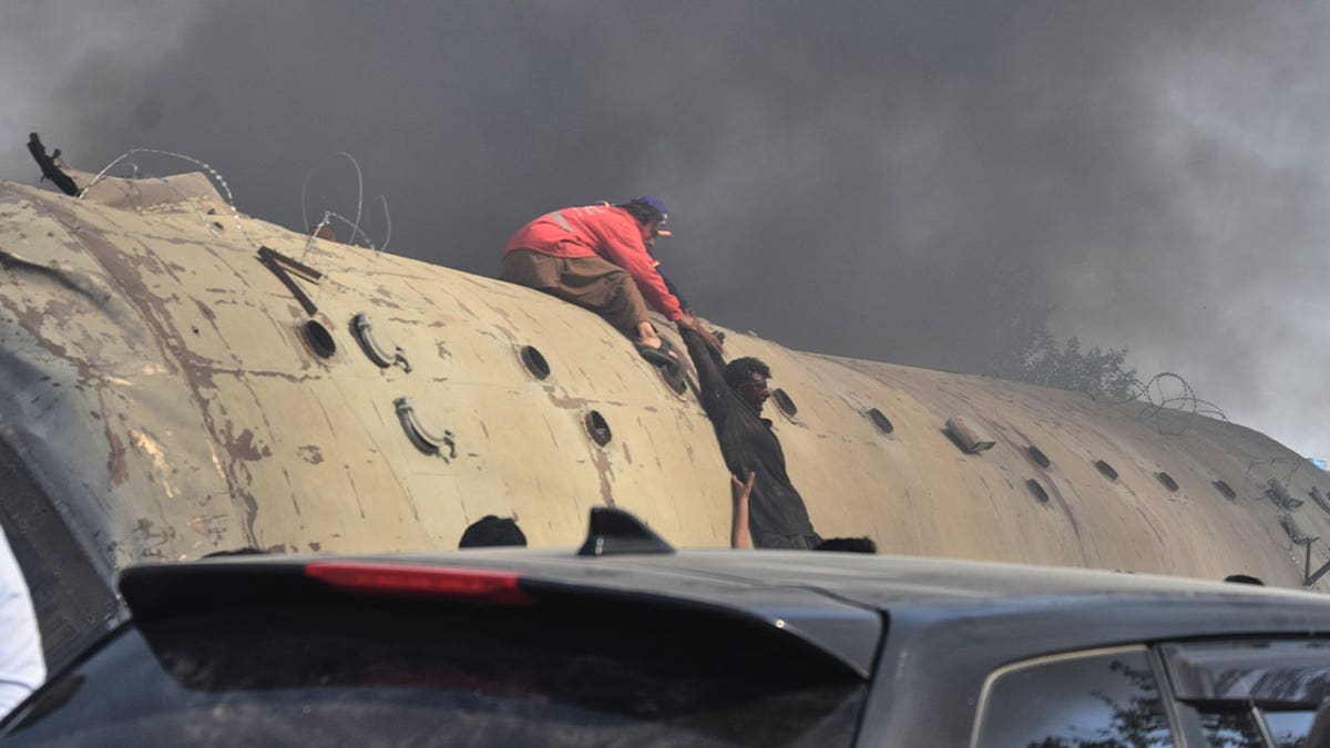 Rescuers pulling survivor up train