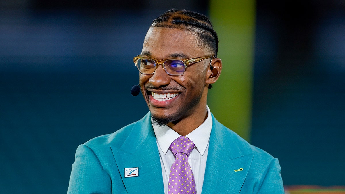 Robert Griffin III standing and looking on before a football game at EverBank Stadium