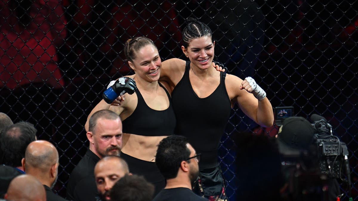Ronda Rousey applying armbar submission on Gina Carano in MMA fight
