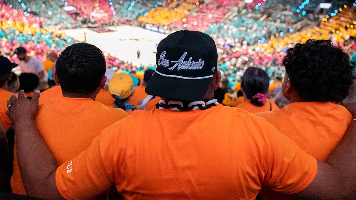Fans watching the first half of a basketball game at Frost Bank Center in San Antonio