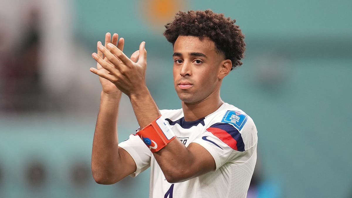 Tyler Adams saluting fans at Khalifa International Stadium in Doha