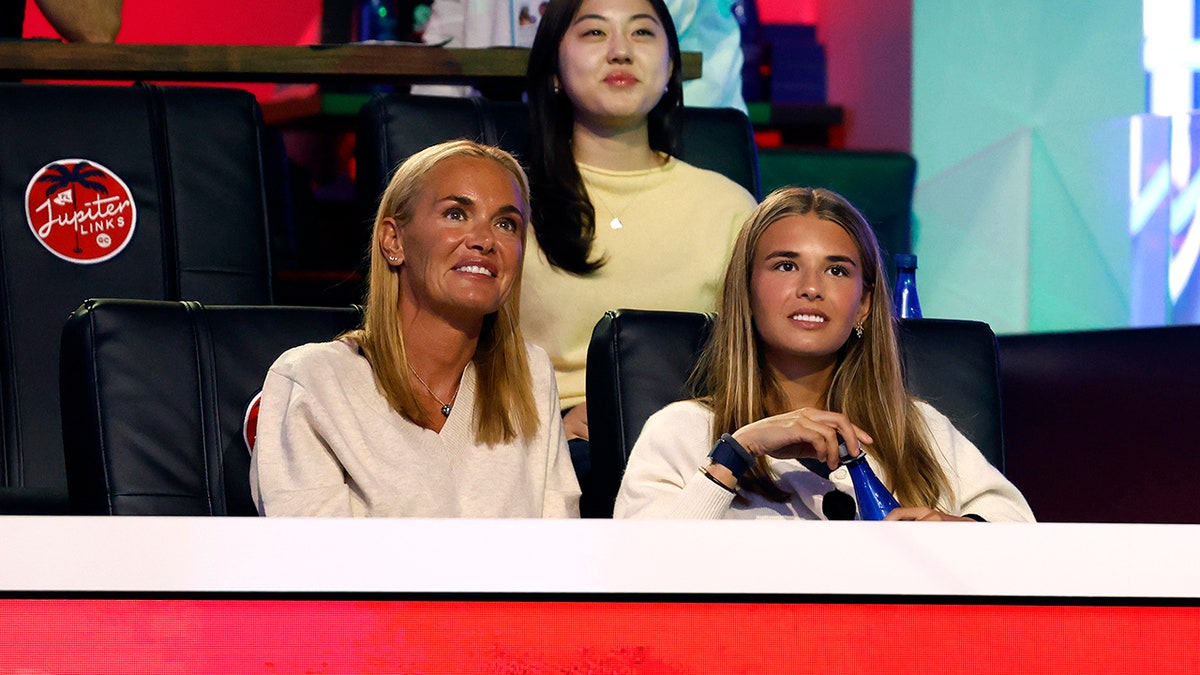 Vanessa Trump and Kai Trump seated at a golf match at SoFi Center